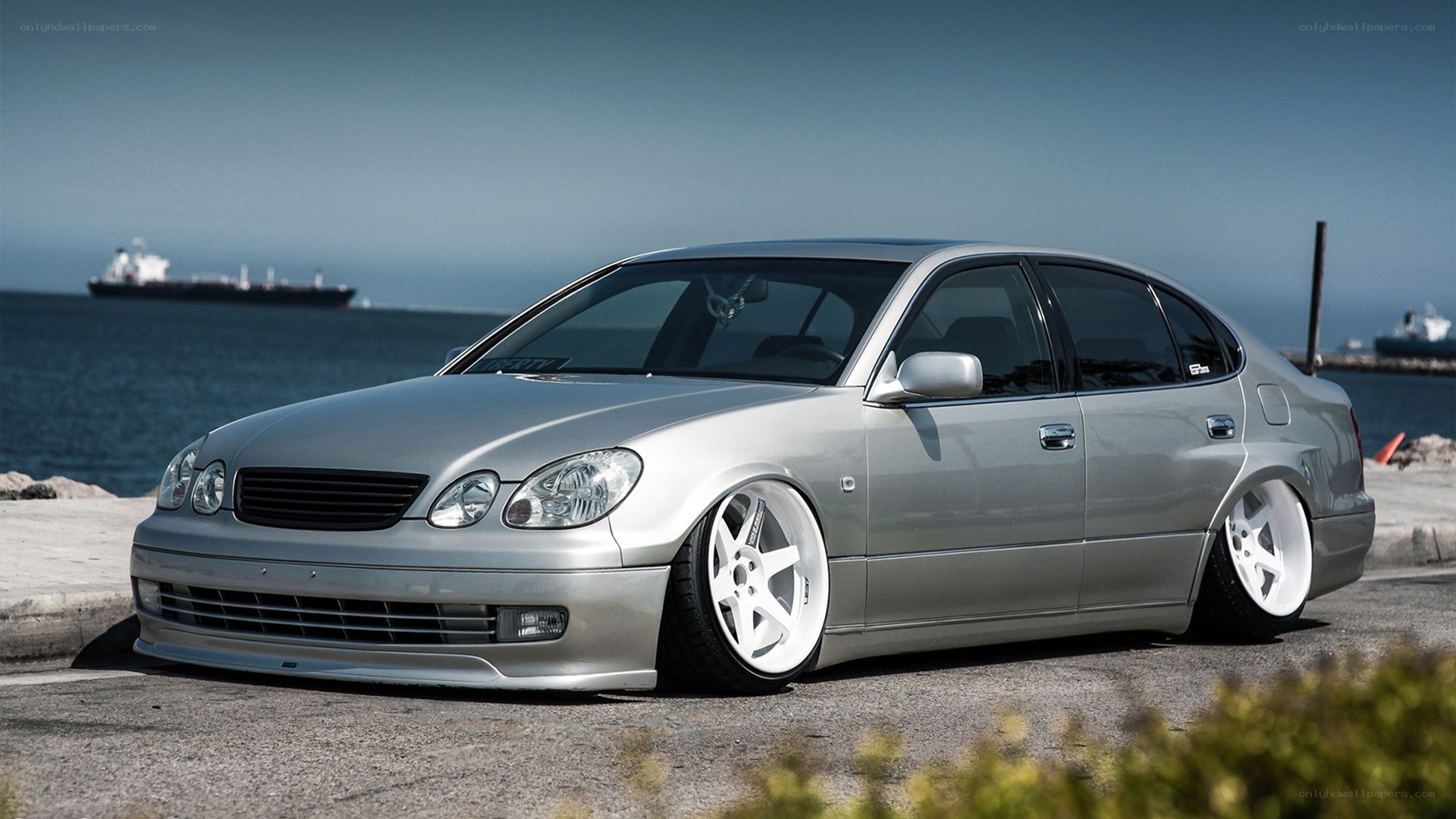 silver sedan by the sea