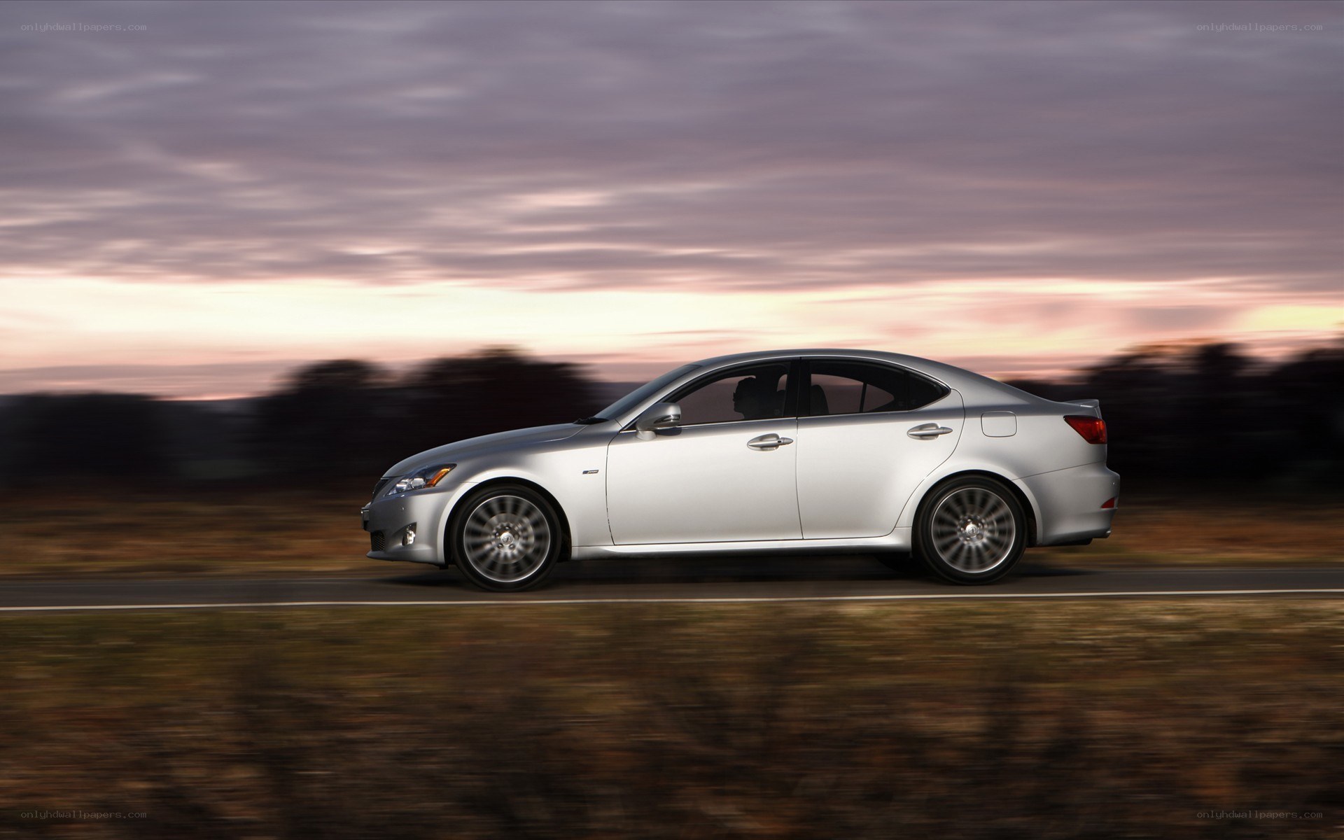 silver sedan driving at dusk