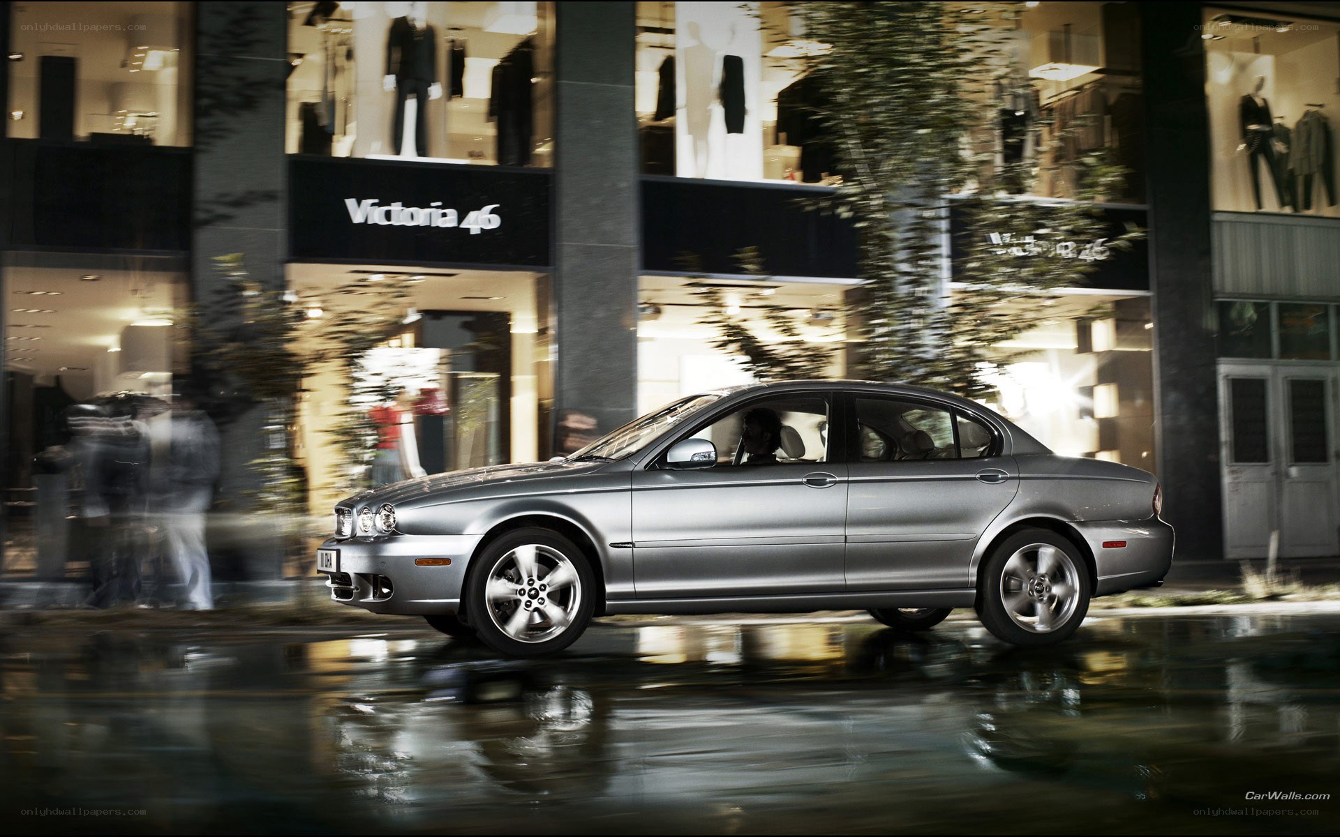 Silver sedan driving at night