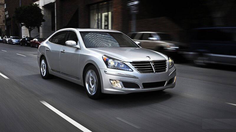 silver sedan driving on city street