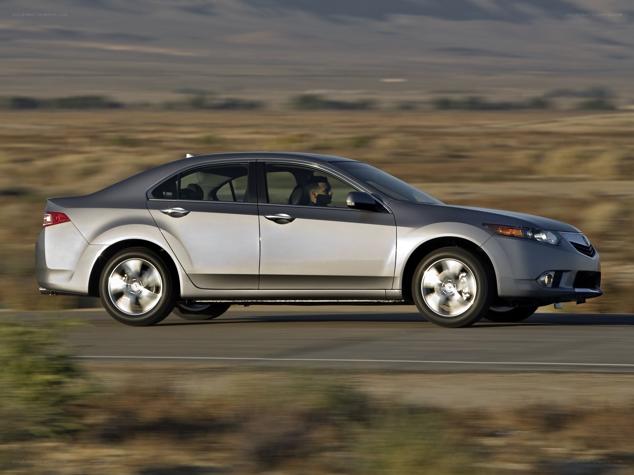 silver sedan driving on road