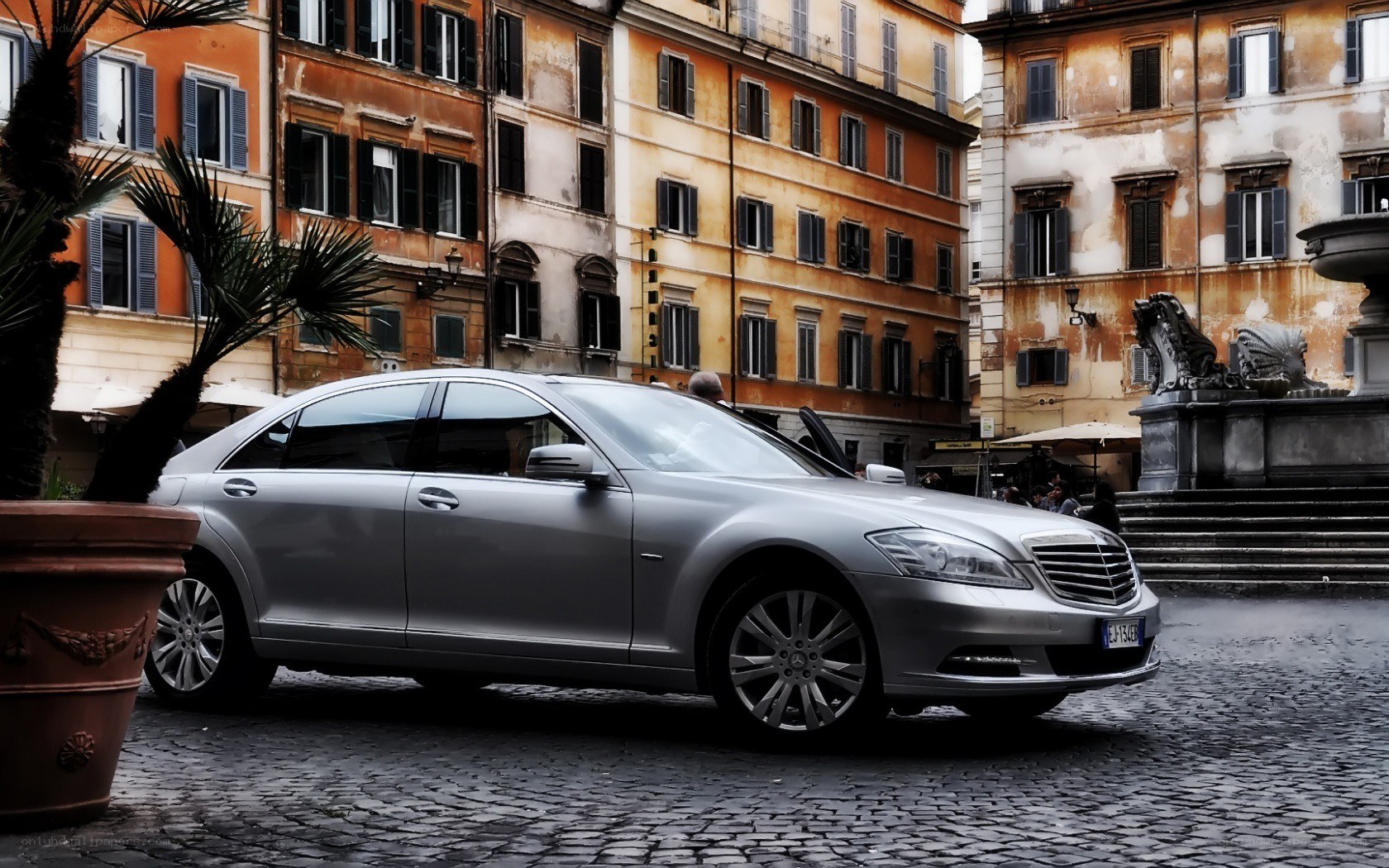 Silver sedan in a European square