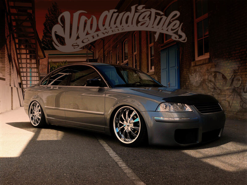 silver sedan in alleyway