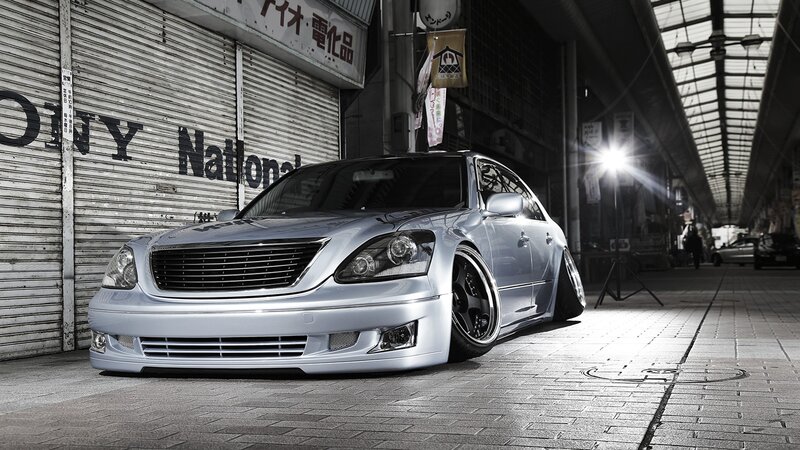 silver sedan in alleyway