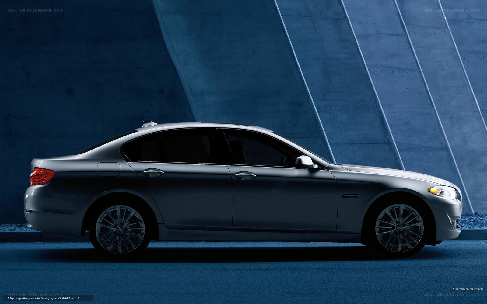 silver sedan in blue tunnel