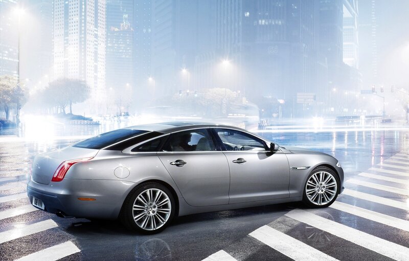 Silver sedan in city at night