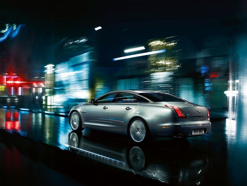 Silver sedan in city at night