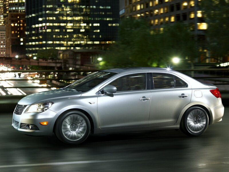 Silver sedan in city at night