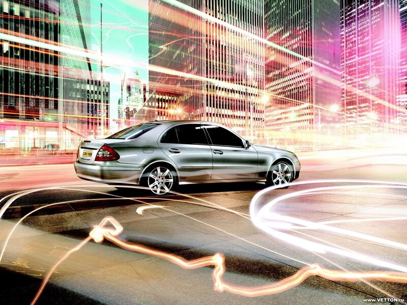 Silver sedan in city at night