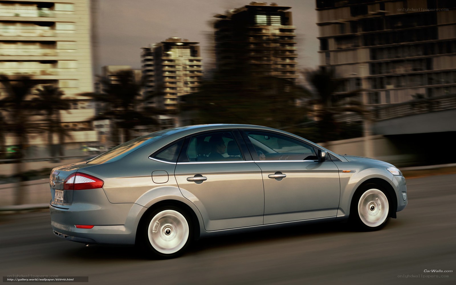 silver sedan in city traffic