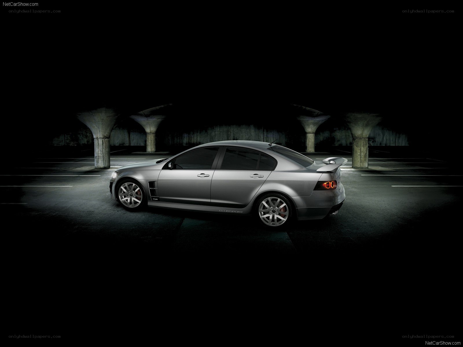 silver sedan in dark parking