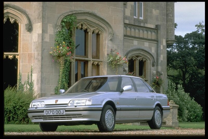 Silver sedan in front of a castle