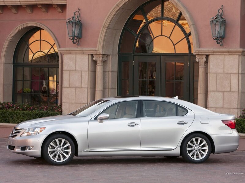 silver sedan in front of building