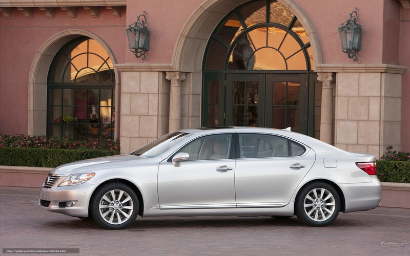 silver sedan in front of building