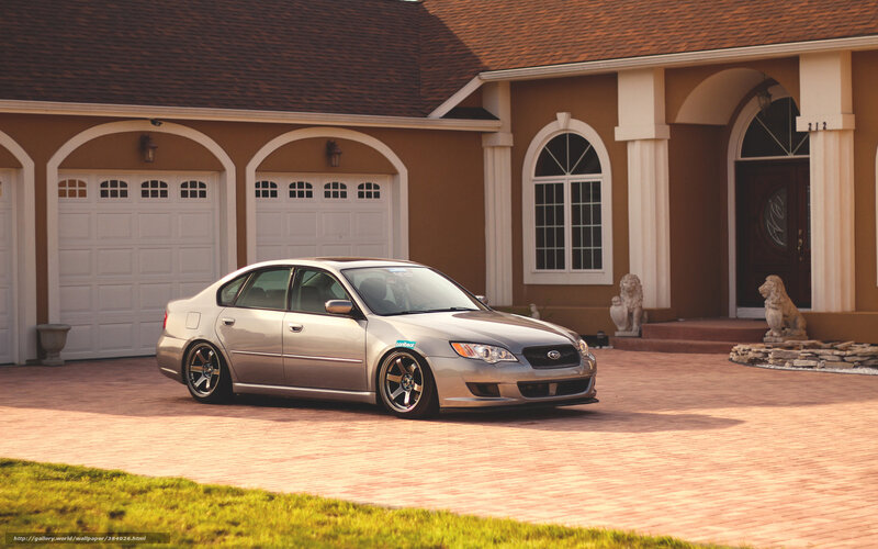 silver sedan in front of house