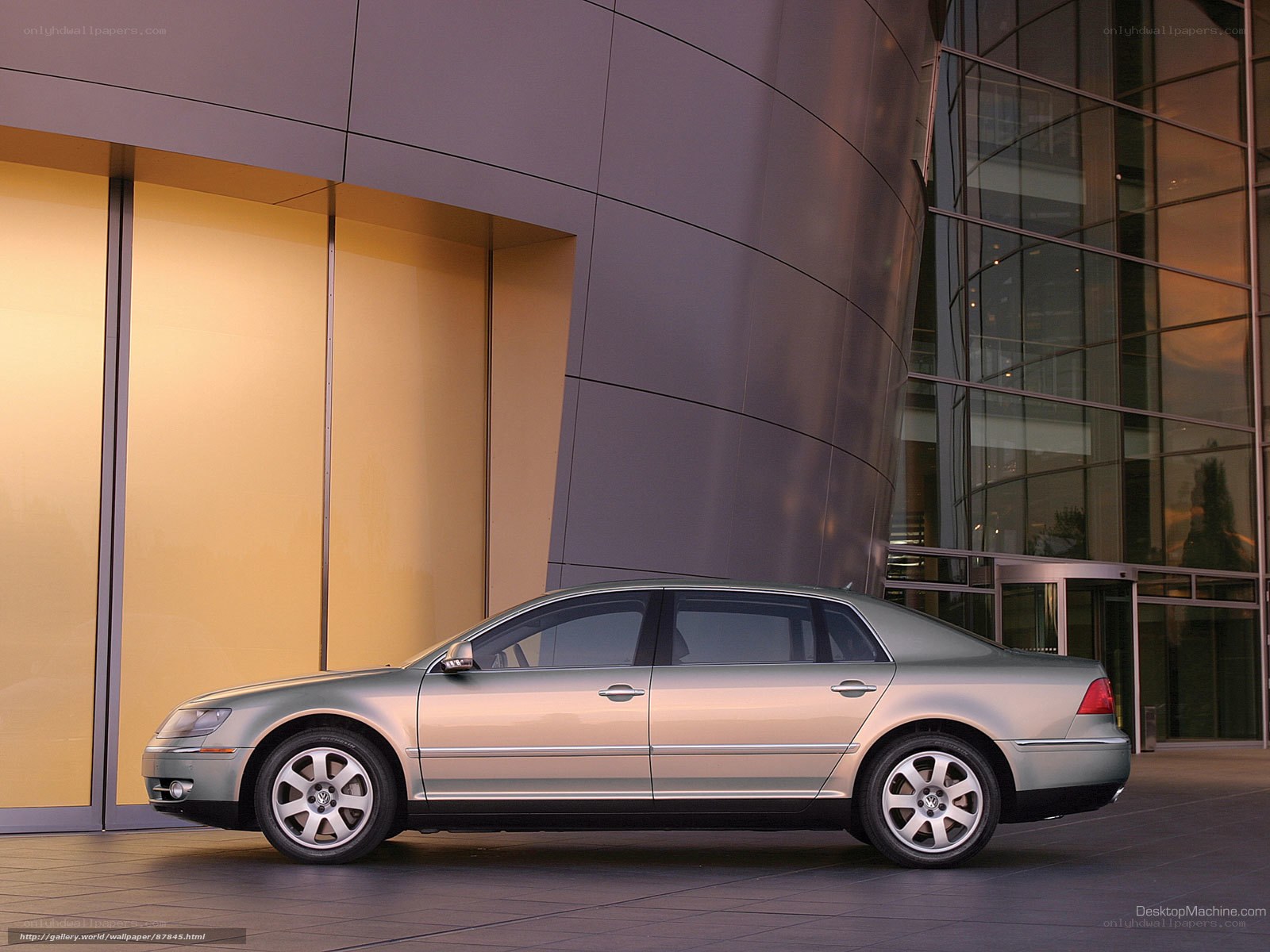 silver sedan in front of modern building