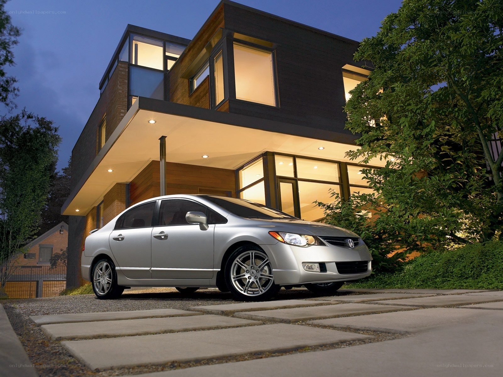 Silver sedan in front of modern house