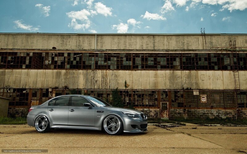 silver sedan in front of old building