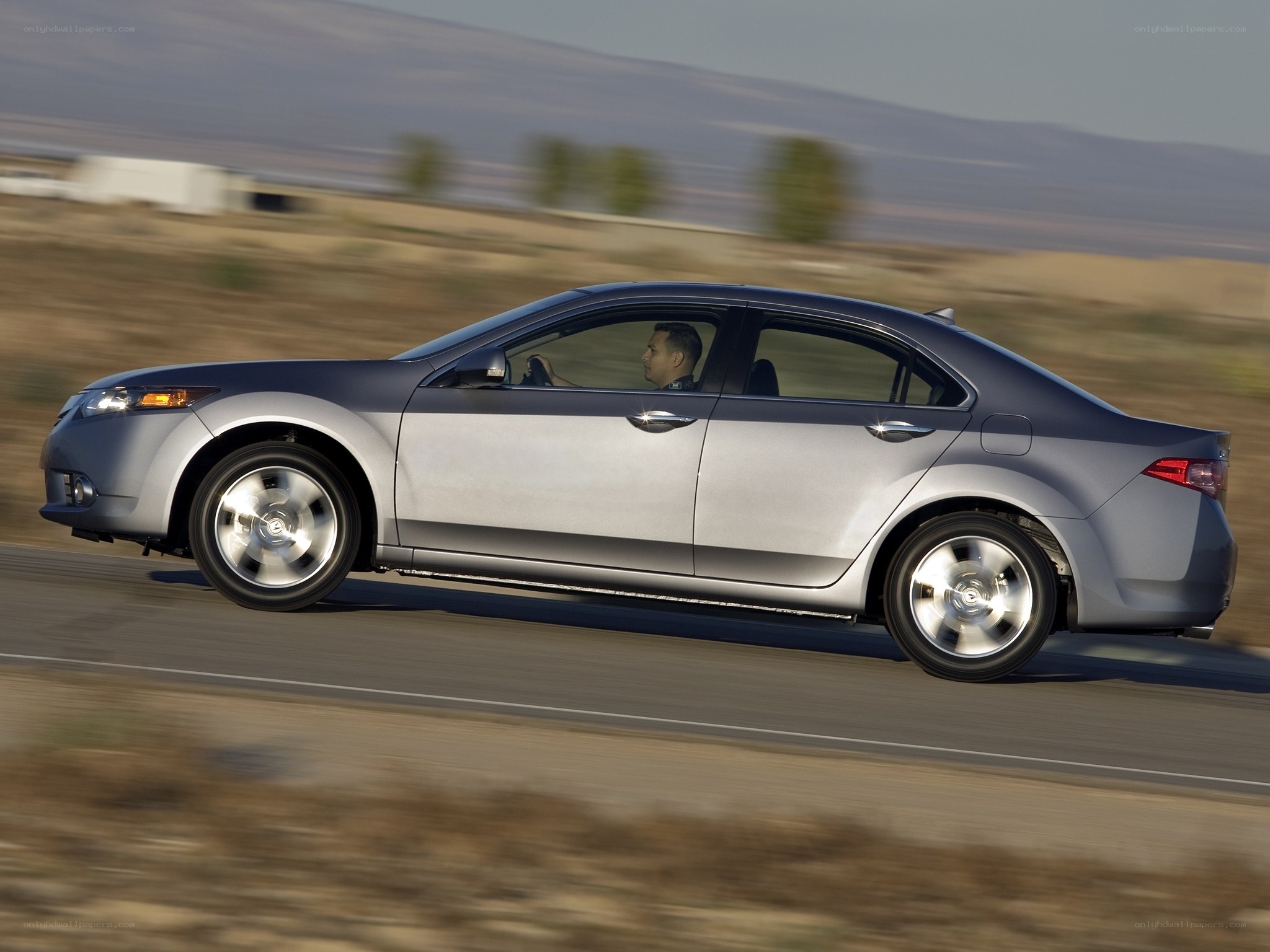 silver sedan in motion