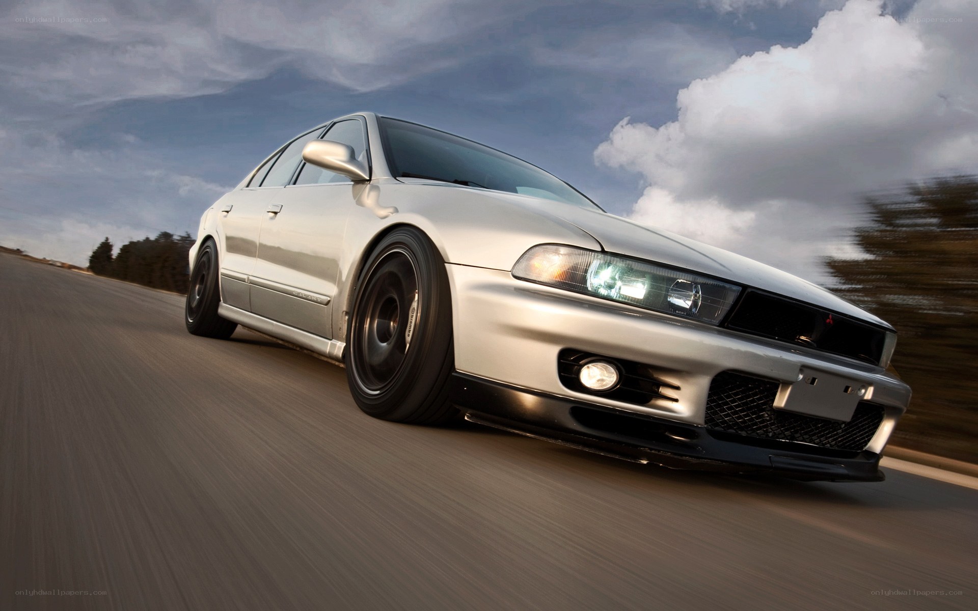 silver sedan in motion