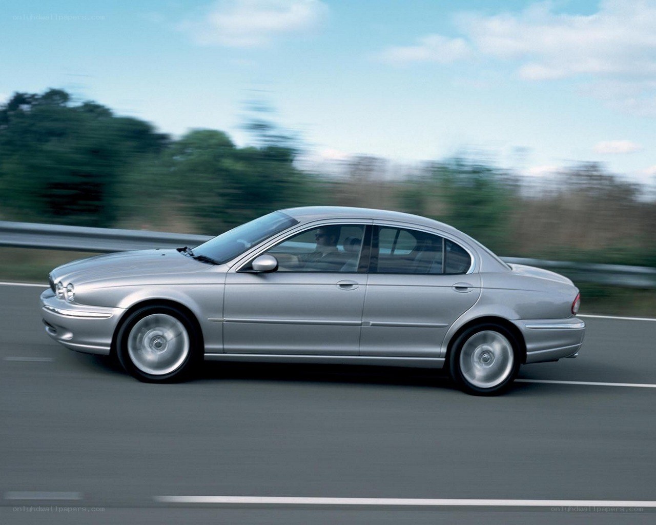 silver sedan in motion