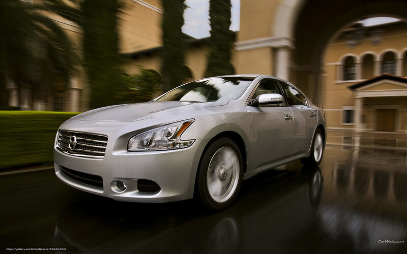 silver sedan in motion