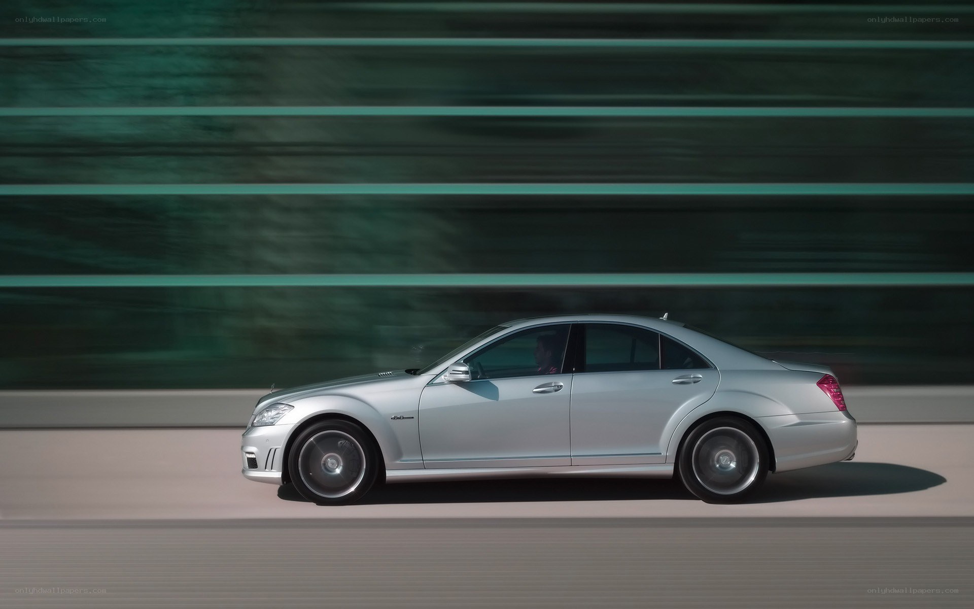 silver sedan in motion