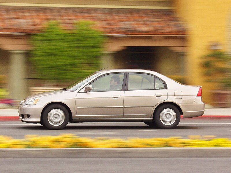 silver sedan in motion
