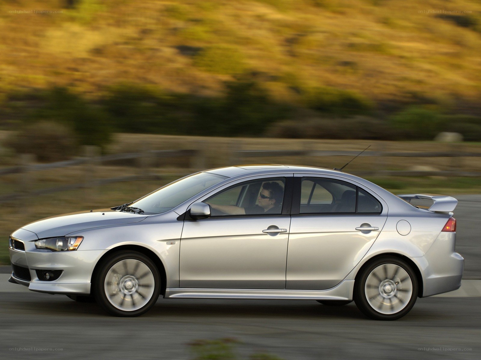 silver sedan in motion