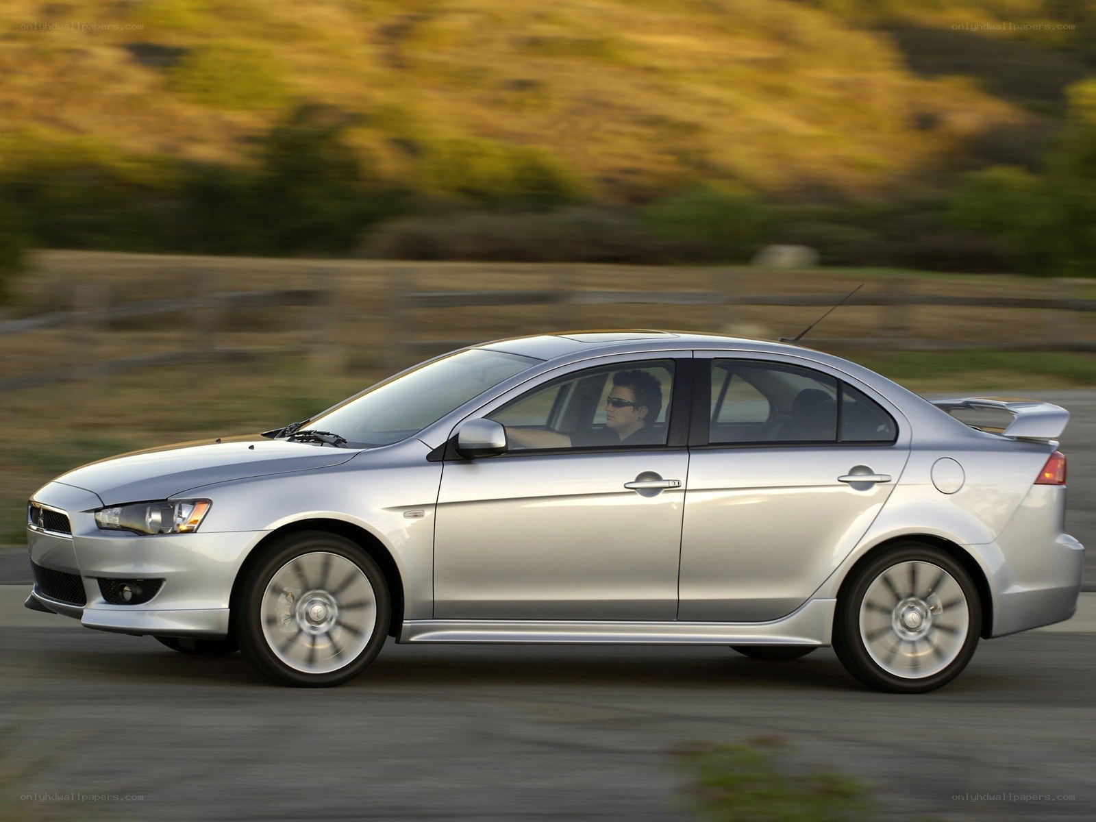 silver sedan in motion
