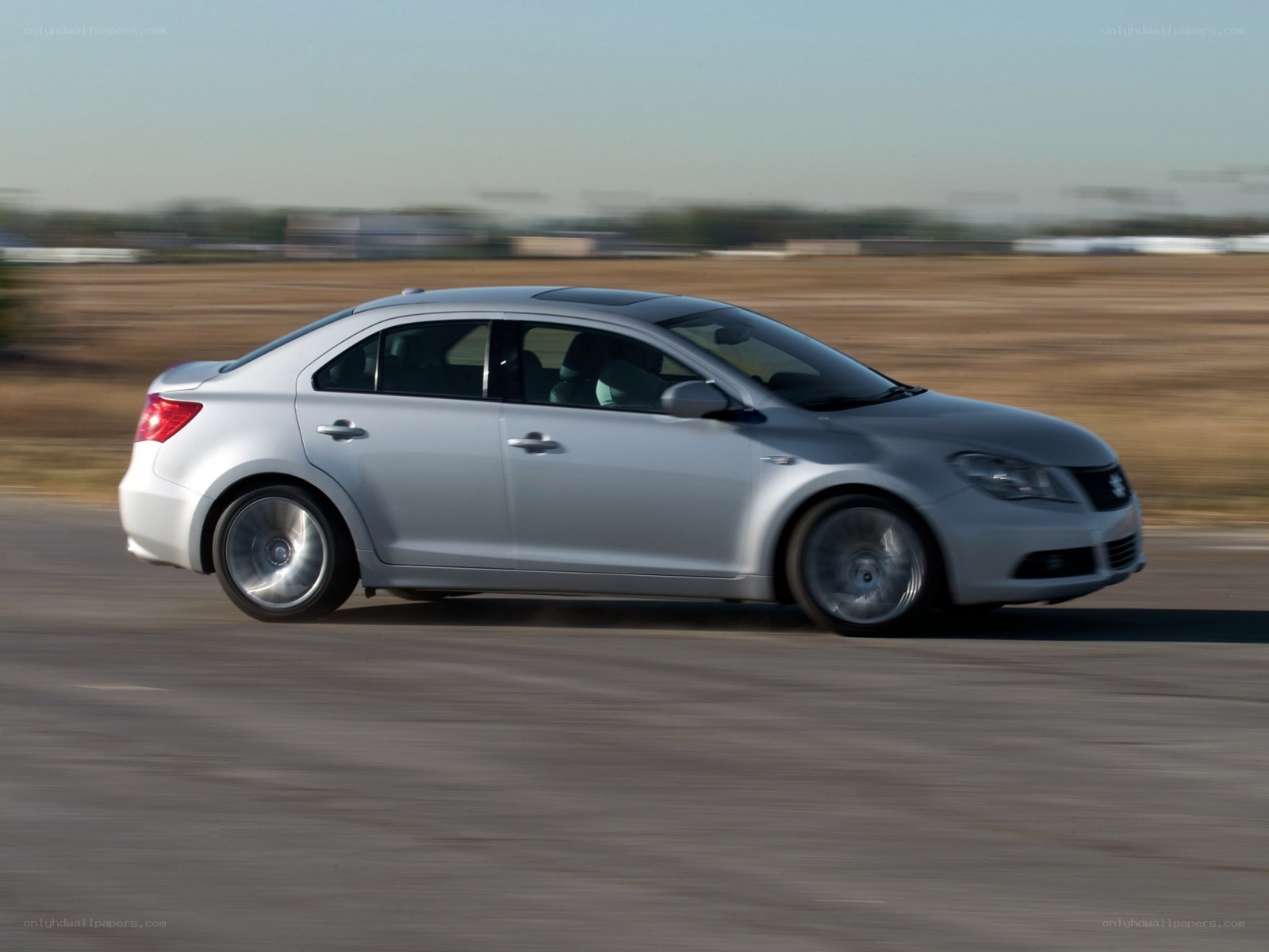 silver sedan in motion