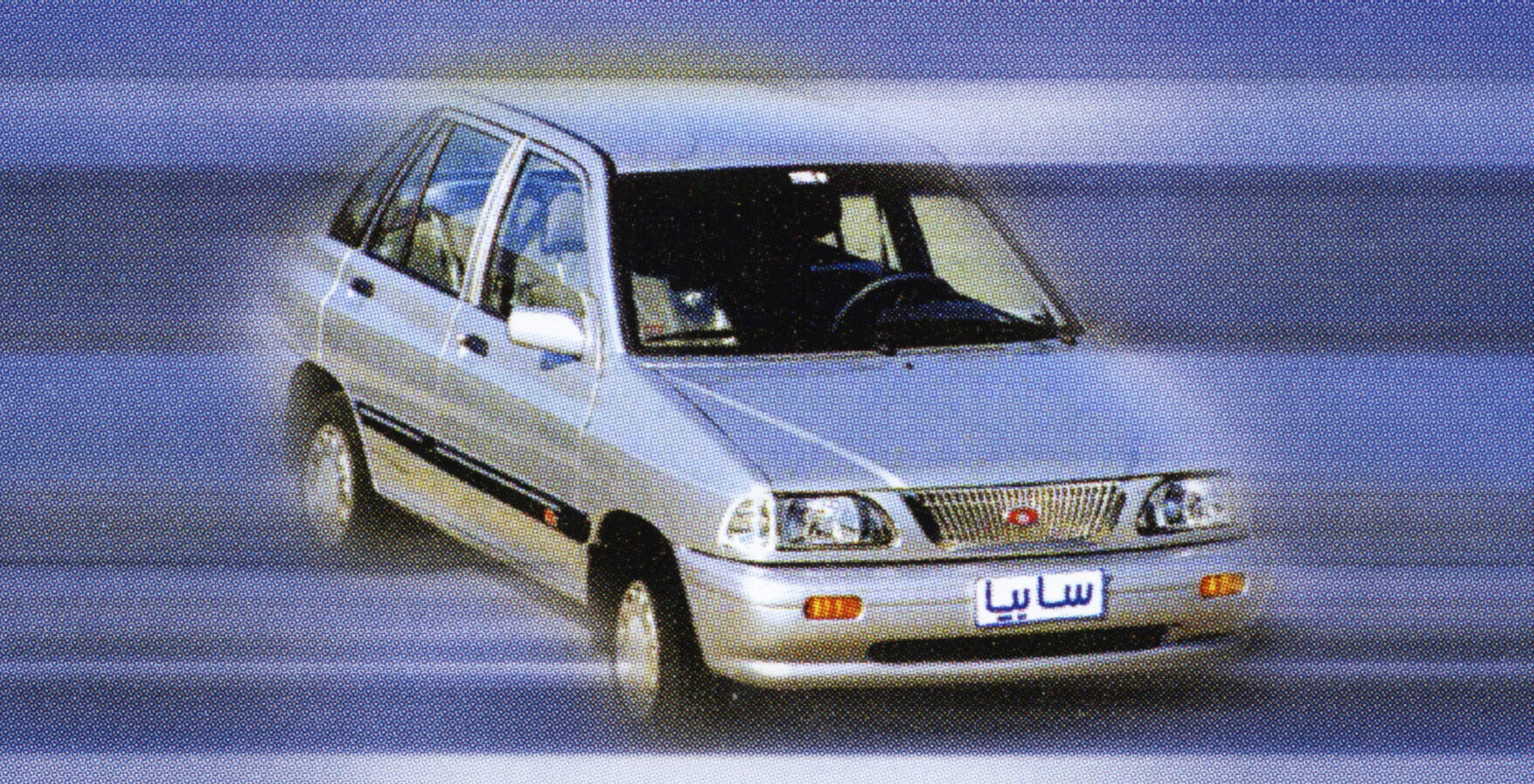 Silver sedan in motion