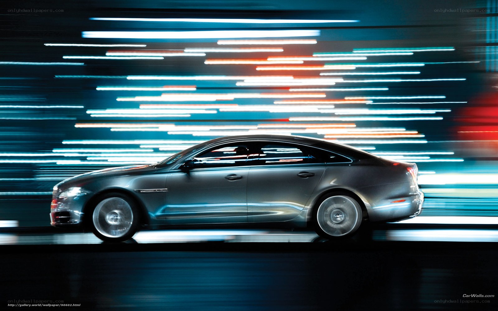 Silver sedan in motion at night