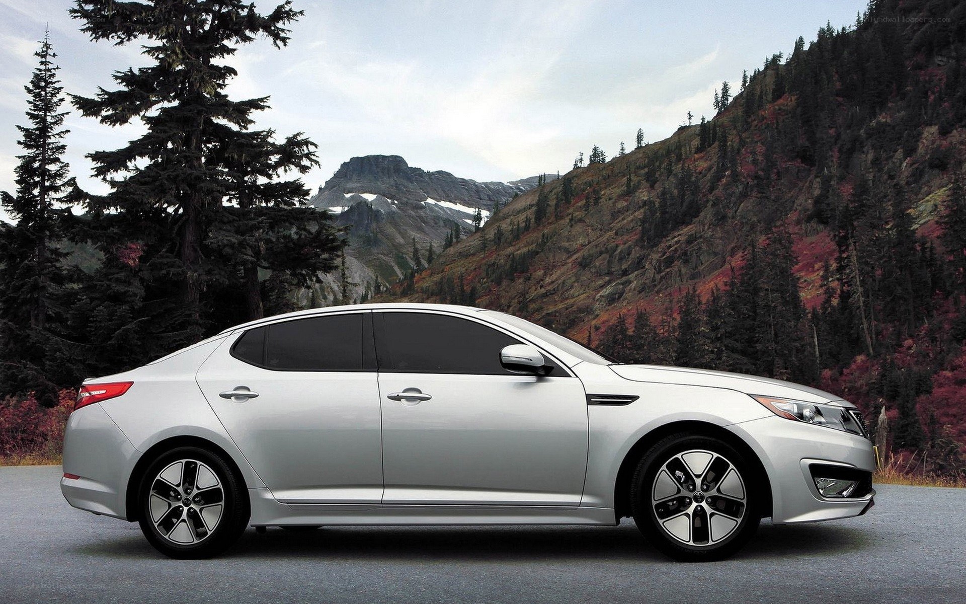Silver sedan in mountain landscape