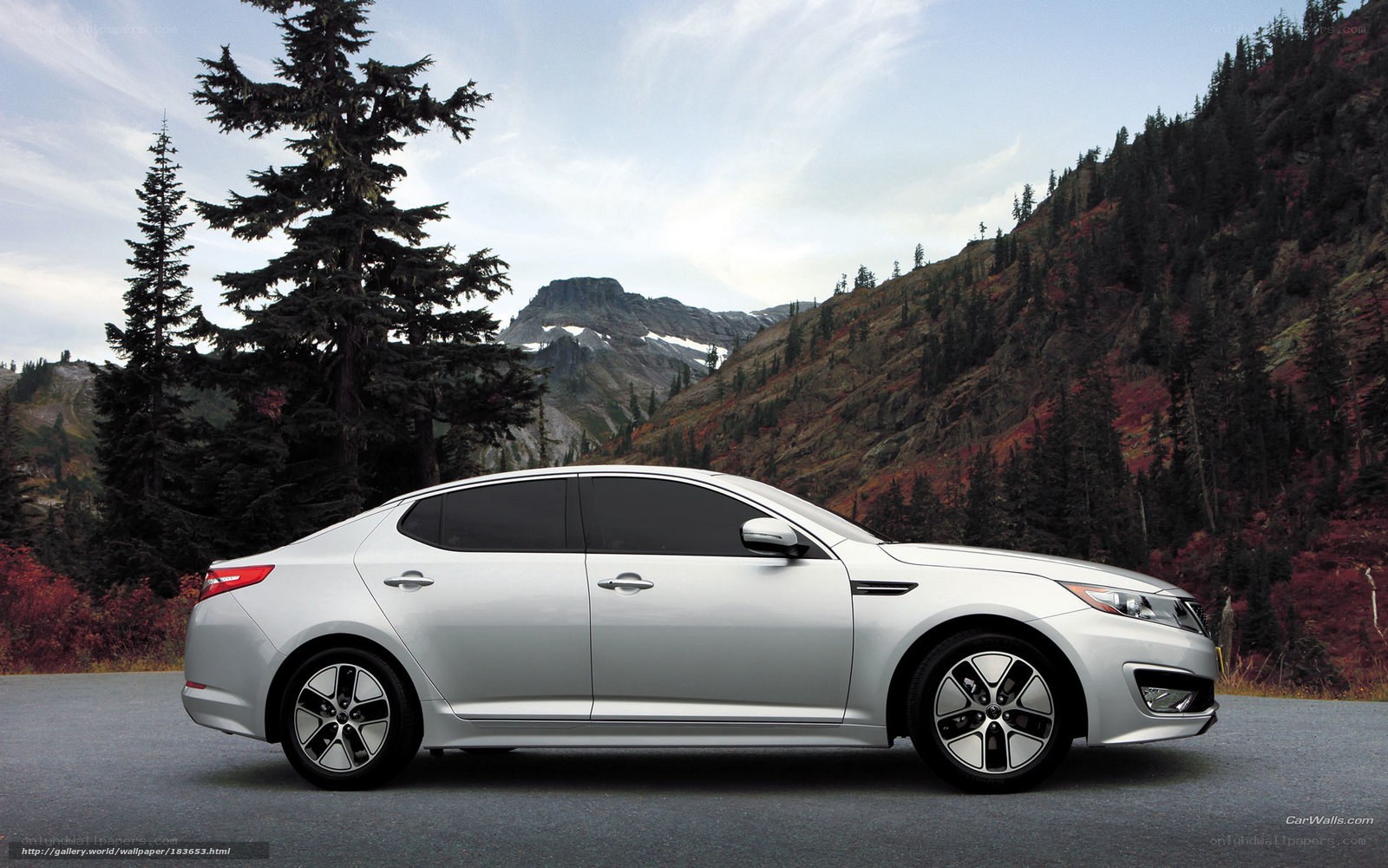 Silver sedan in mountain landscape