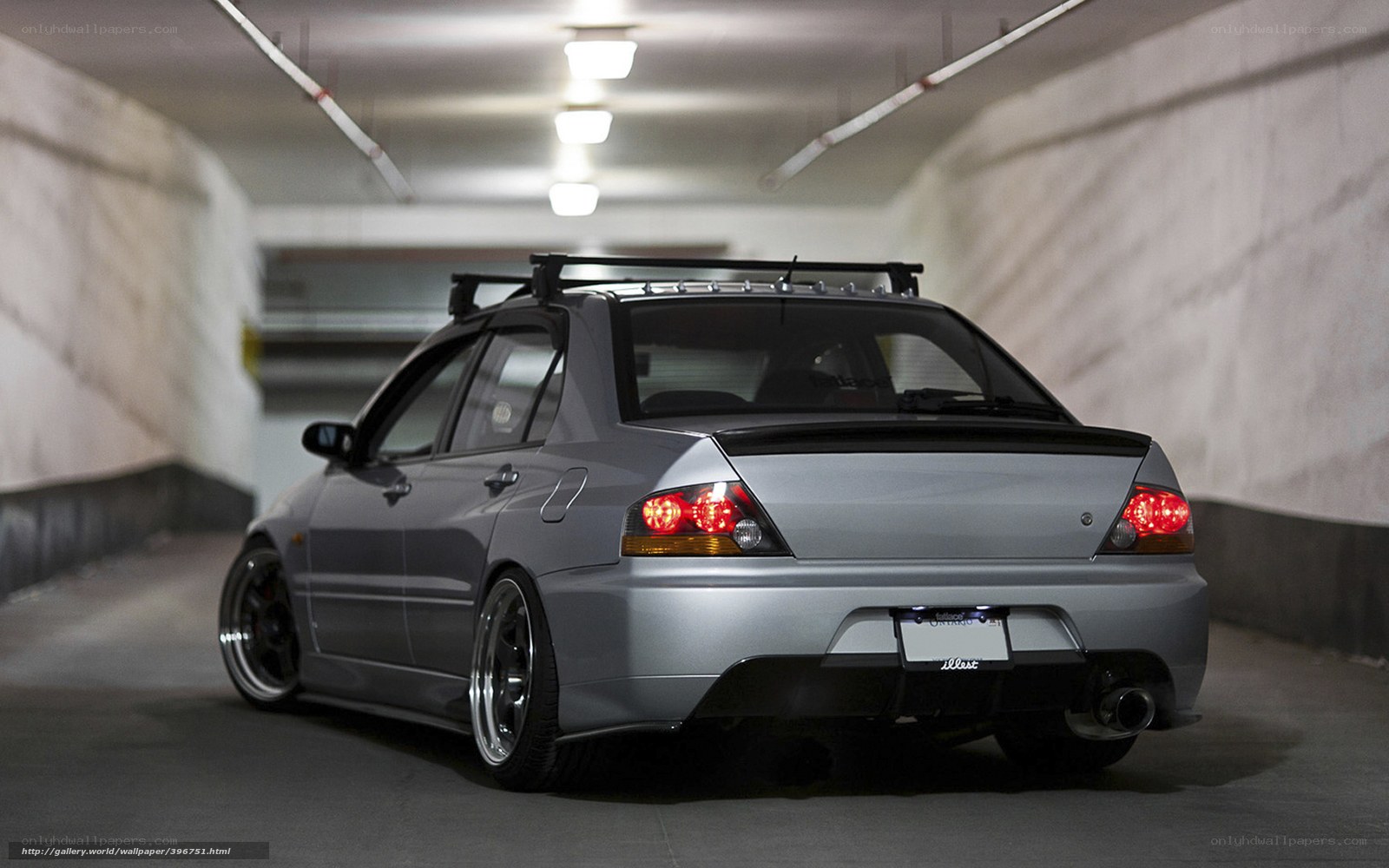 silver sedan in parking garage