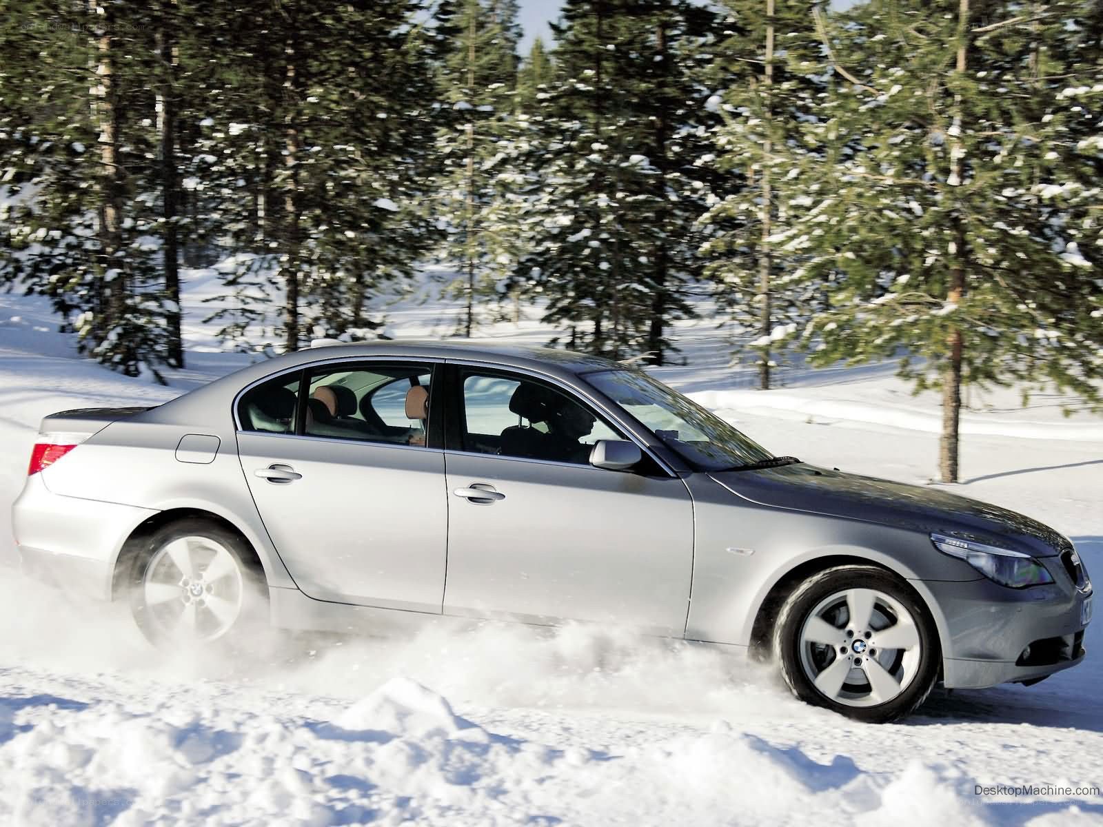 silver sedan in snowy forest