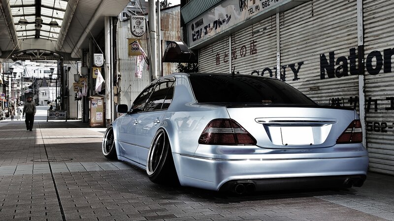 silver sedan in urban alley