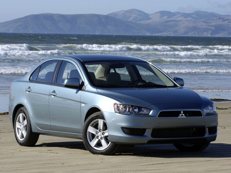 Silver sedan on a beach