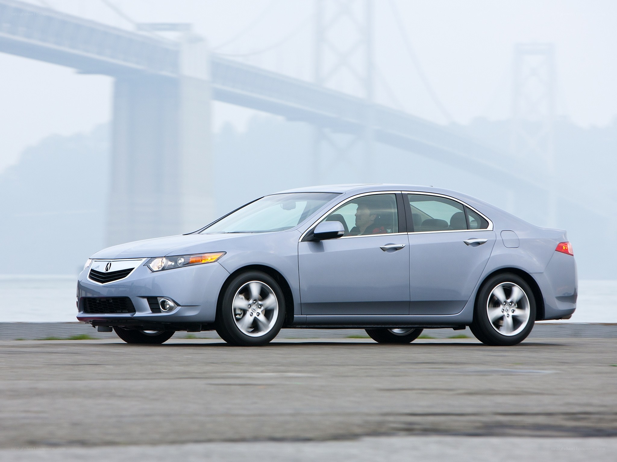 silver sedan on a bridge