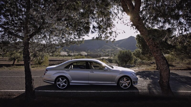 Silver sedan on a country road