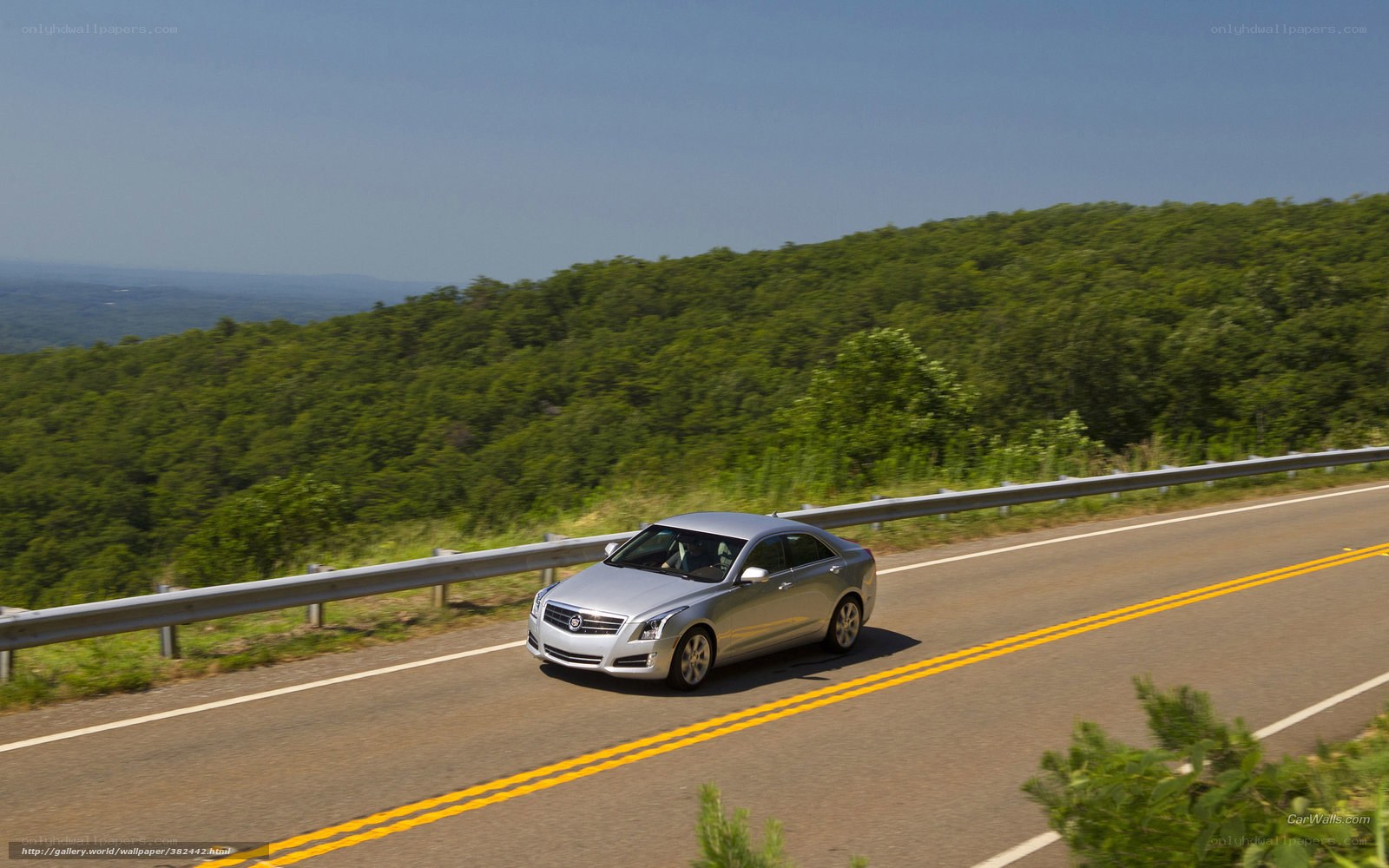 Silver sedan on a scenic road
