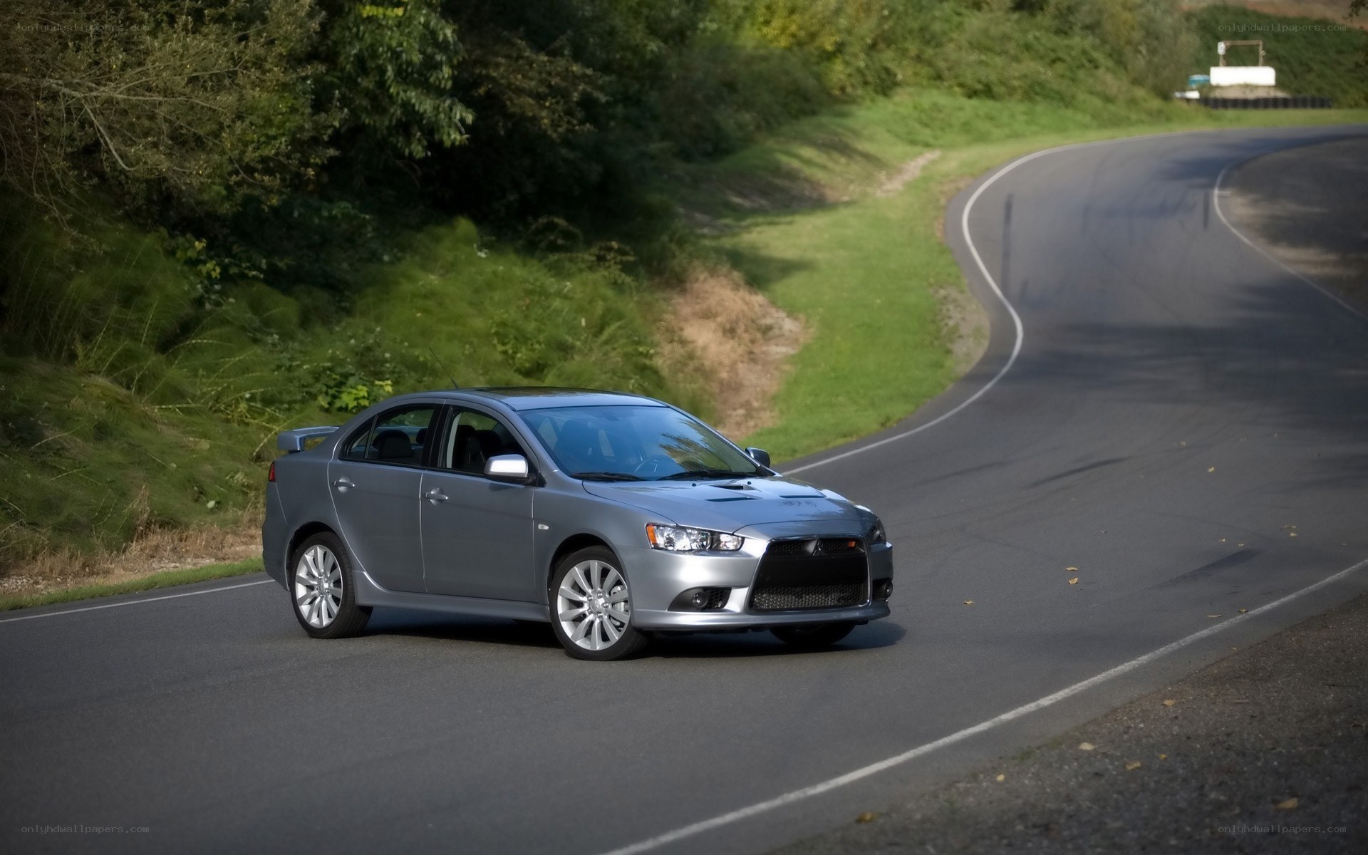 Silver sedan on a winding road