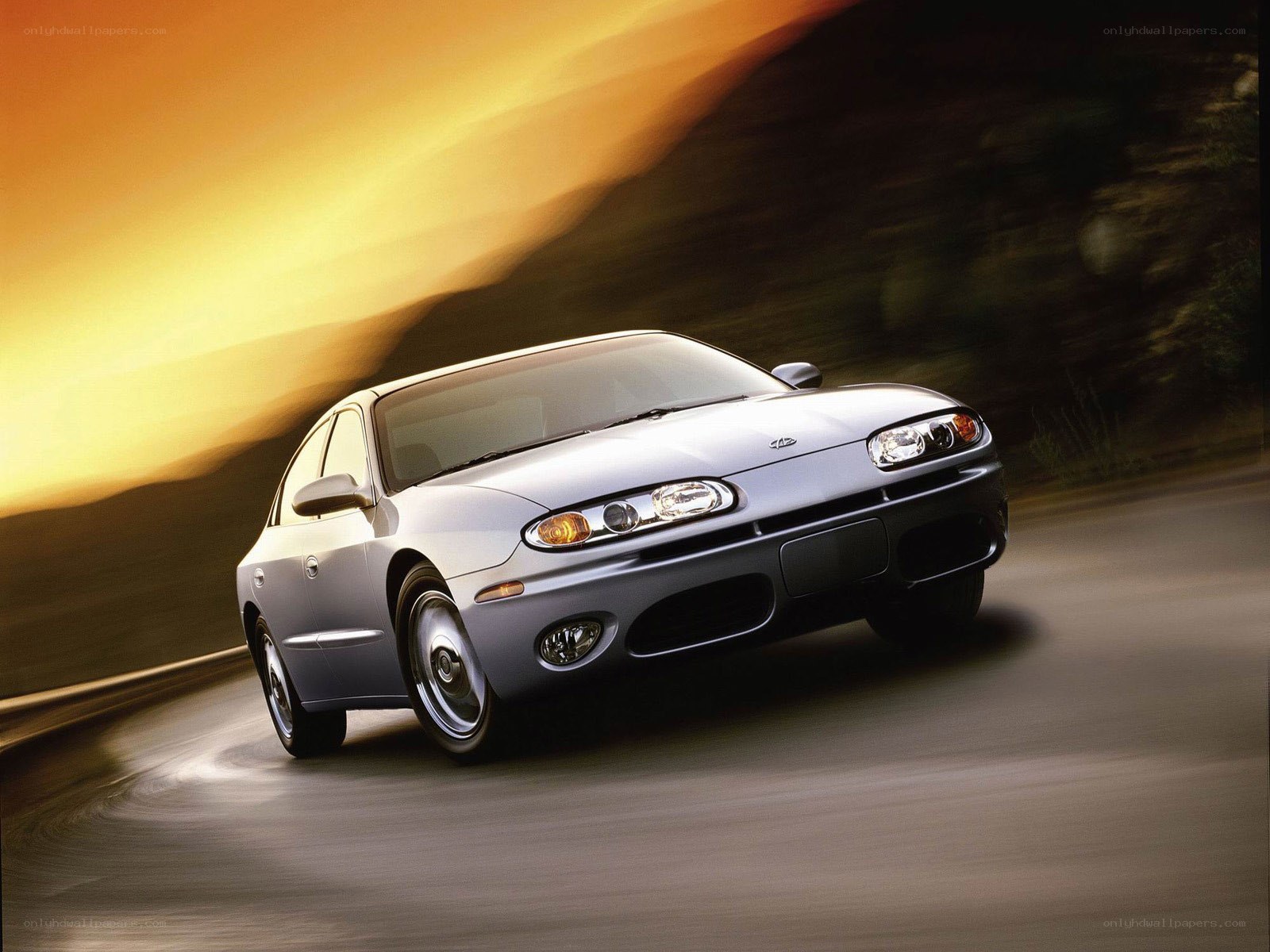 silver sedan on a winding road