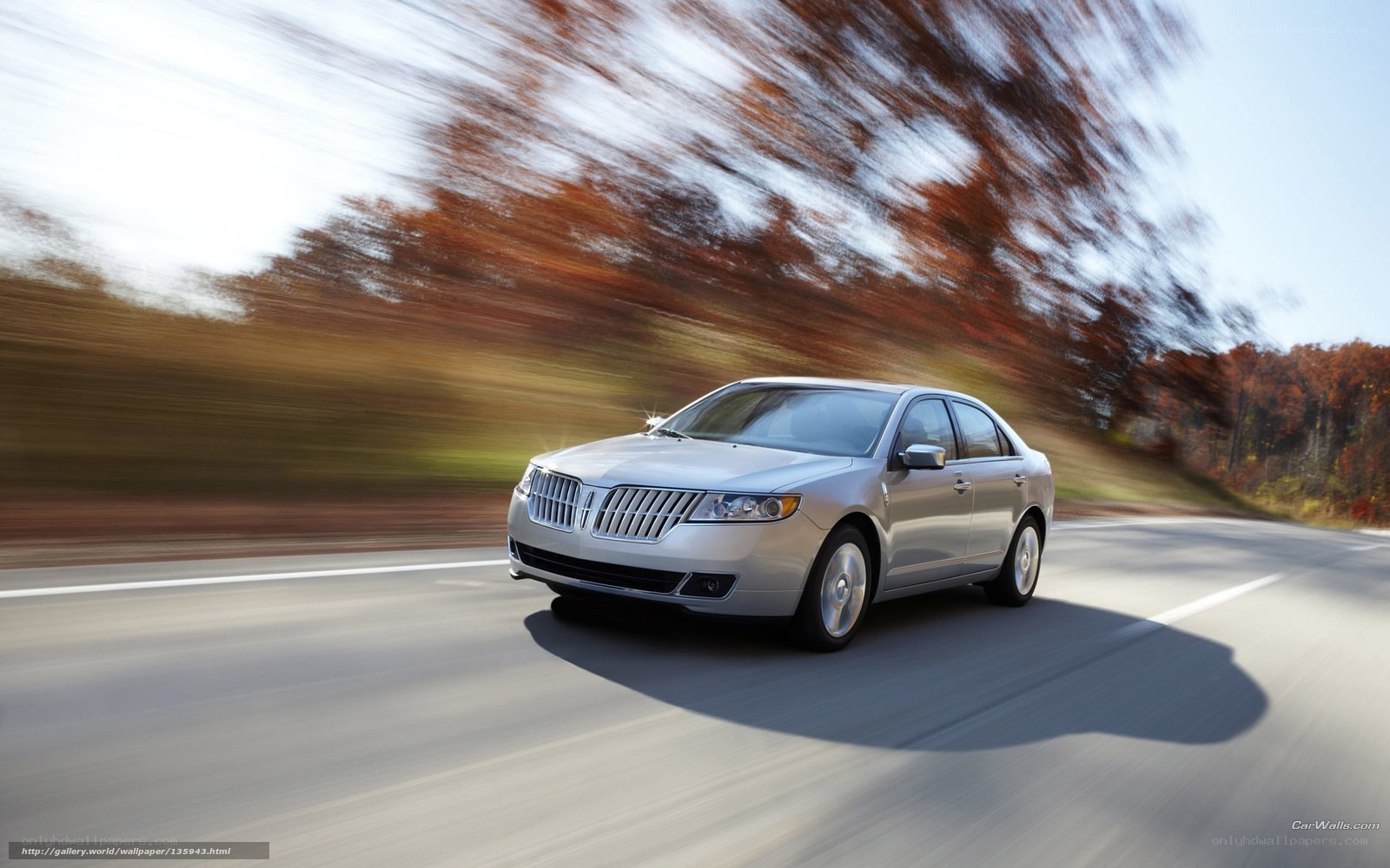 silver sedan on autumn road