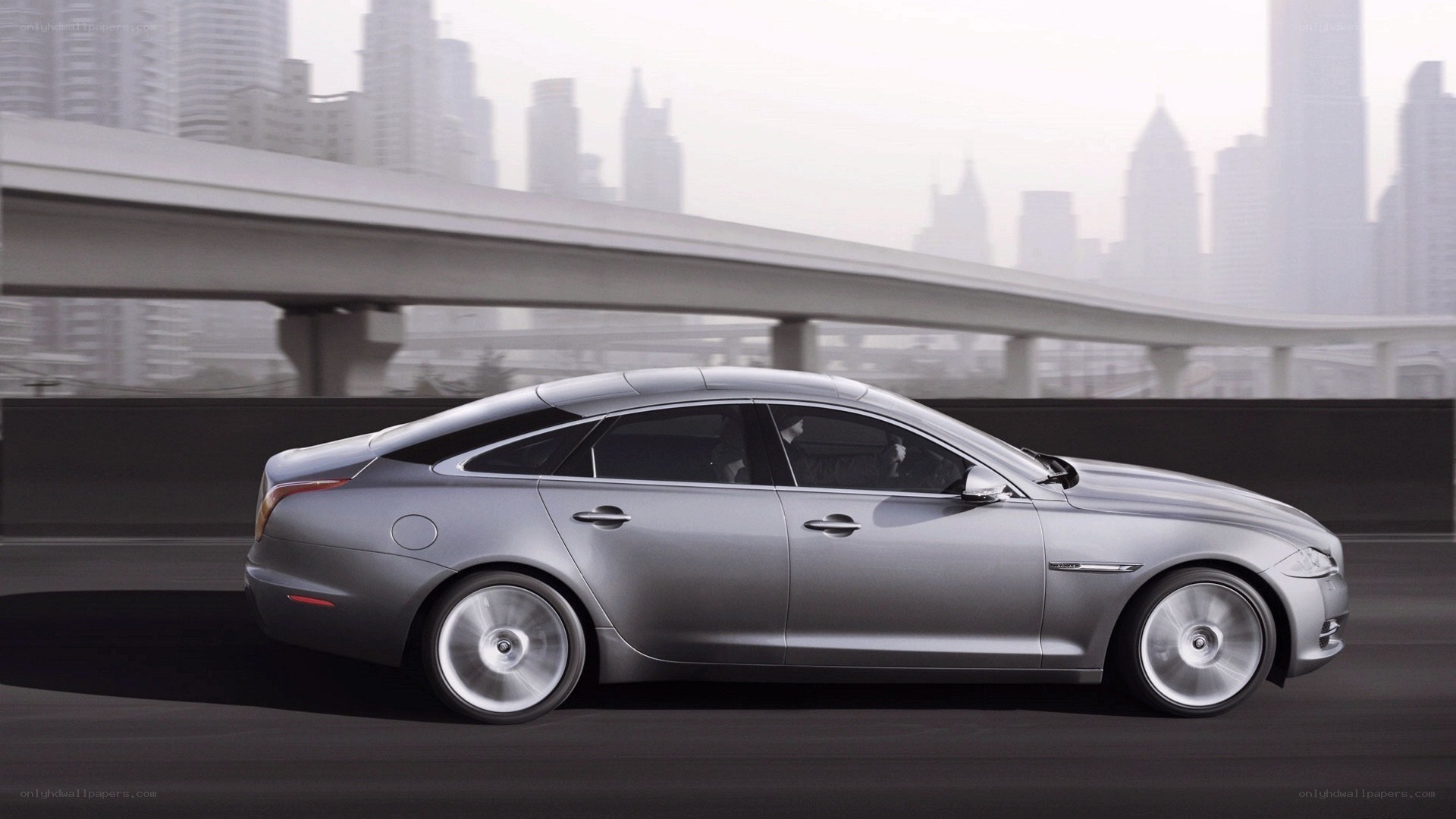 silver sedan on city highway