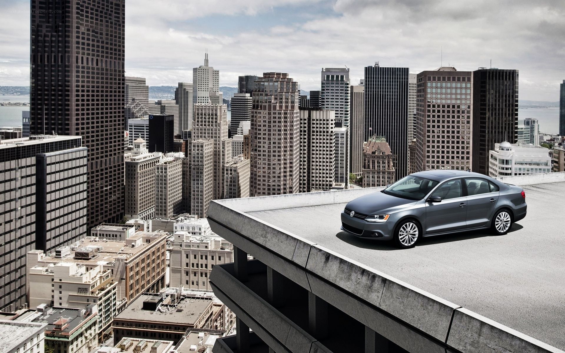Silver sedan on city rooftop