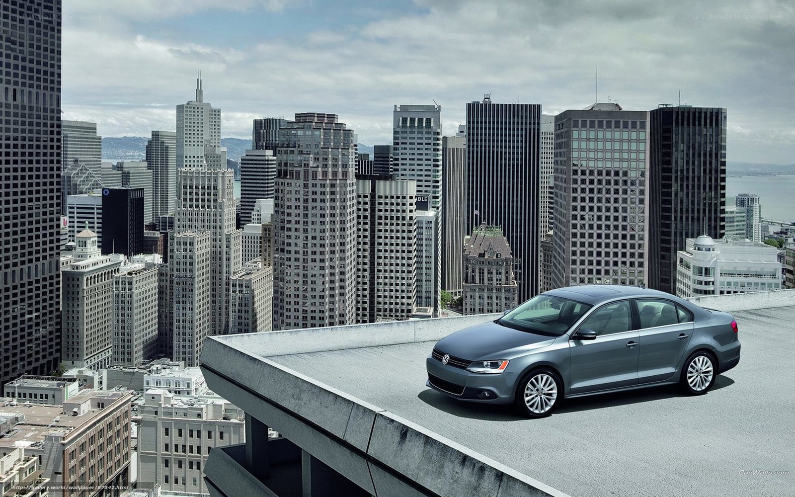 Silver sedan on city rooftop