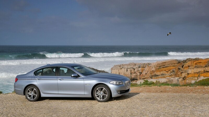 Silver Sedan on Coast — Dramatic
