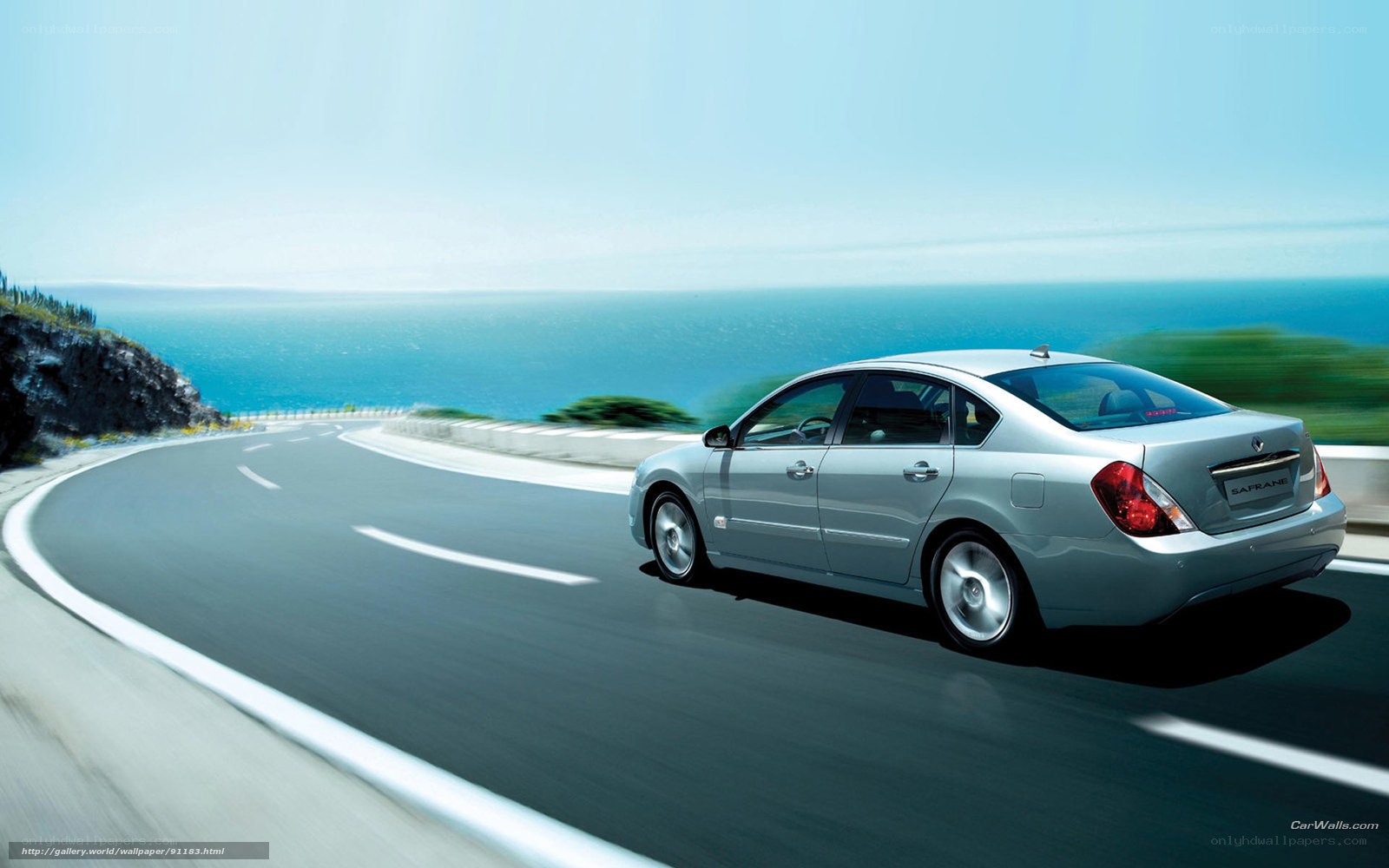 Silver sedan on coastal road